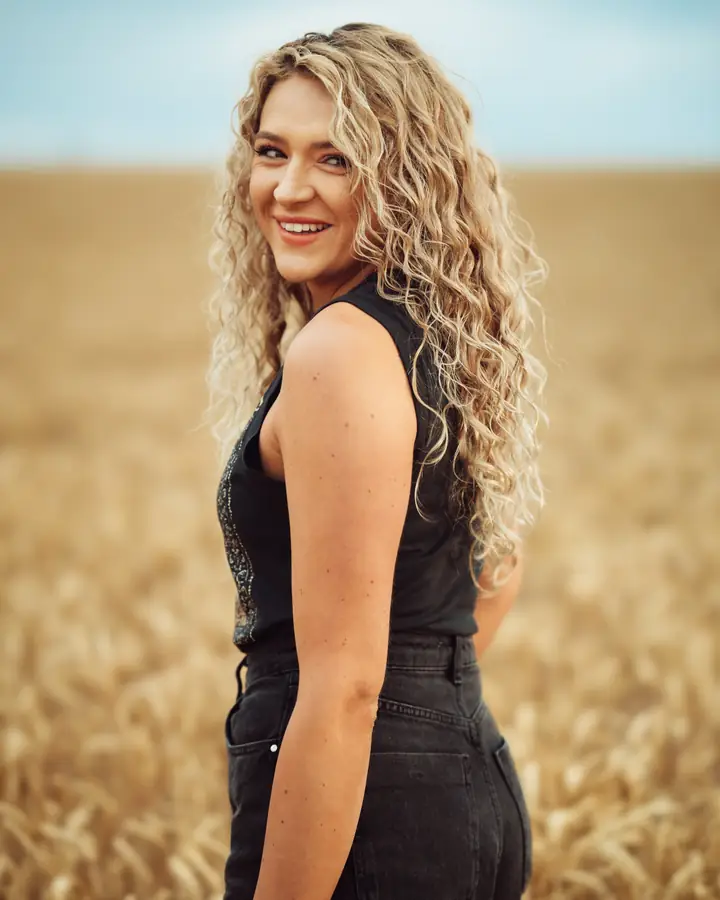 Maddison Ewan smiling in a wheat field